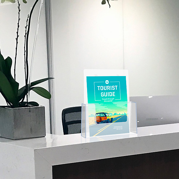 Akryl brochureholder med en turistguide på en skrivebordsdisk